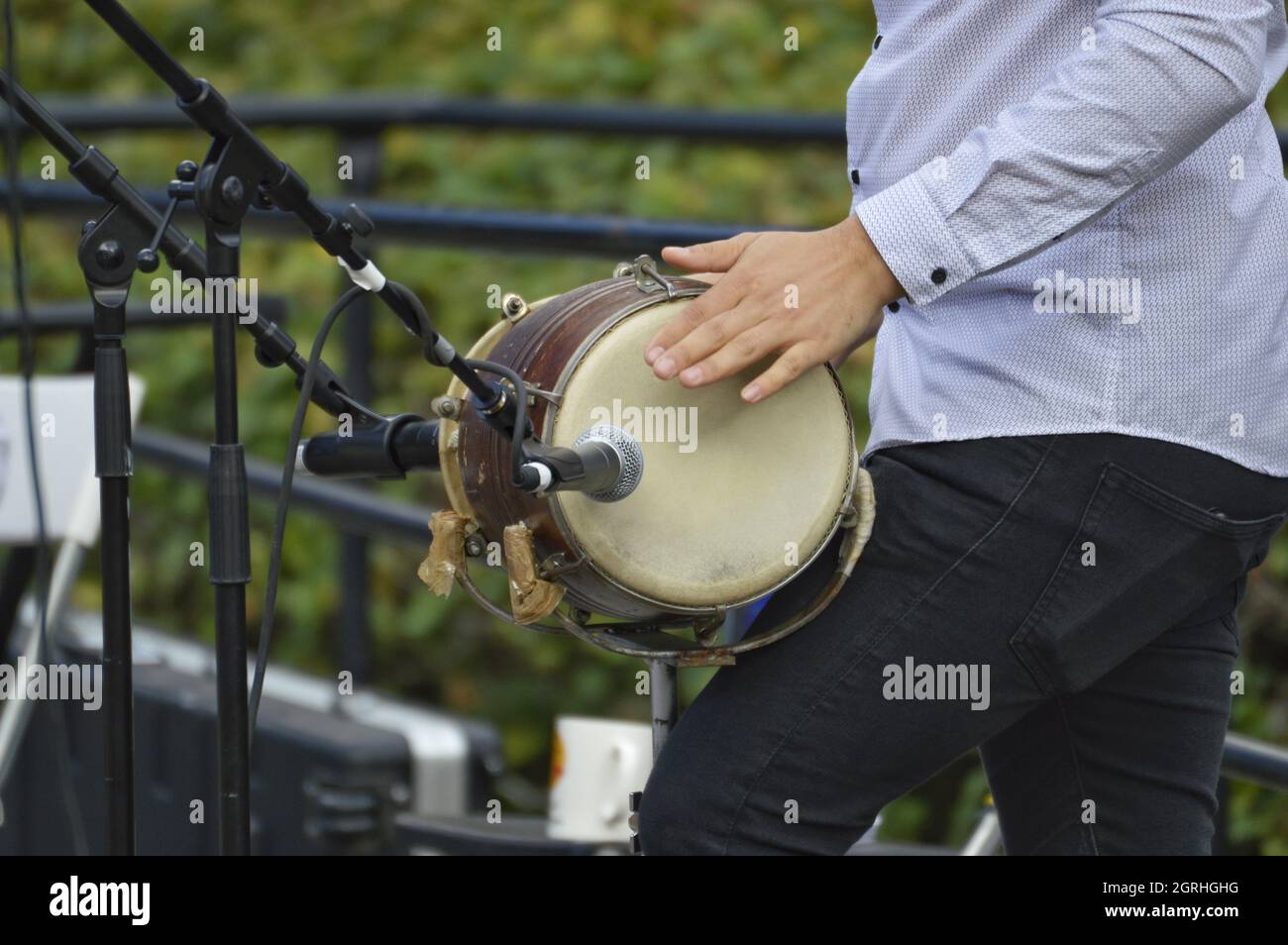 Midsection Of Man Playing Drum During Event Stock Photo