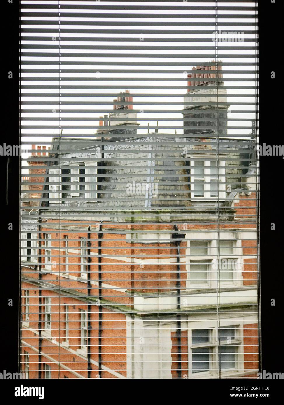 Residential Building Seen Through Window Blinds Stock Photo