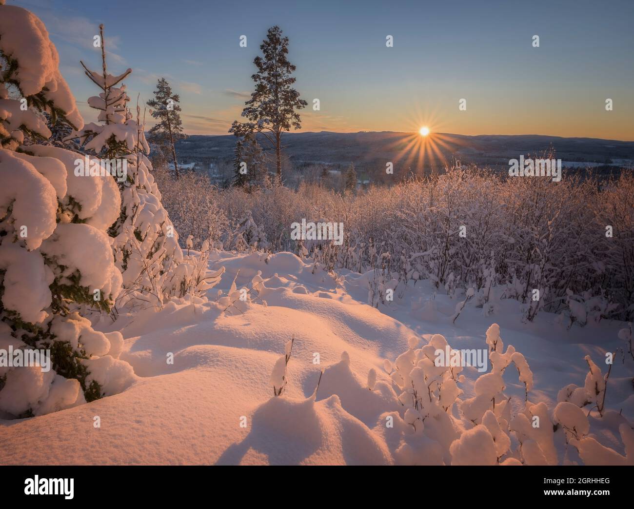 sunset in a winter mountain landscape Stock Photo