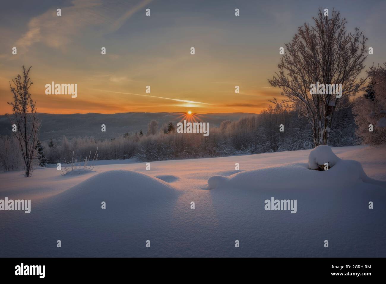 sun rays in a orange winter mountain landscape Stock Photo