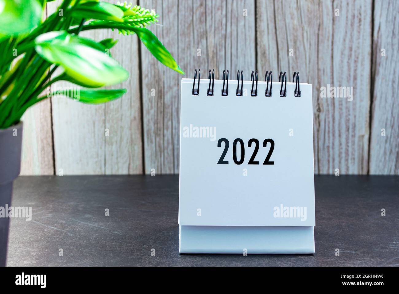 2022 calendar with potted plant on wooden desk. New Year Concept Stock ...