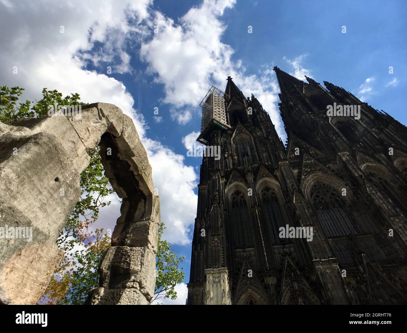 Low Angle View Of Cologne Cathedral Against Cloudy Sky Stock Photo