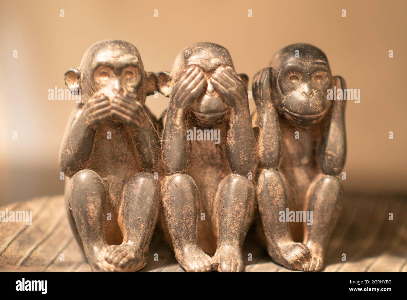 Three wise monkeys, aged brass ornament Stock Photo