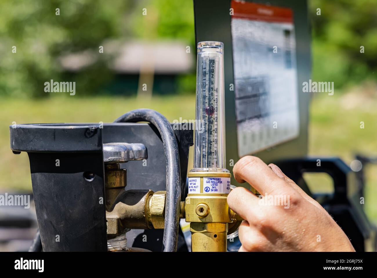 A gas pressure regulator of a welding grinder, a female worker is