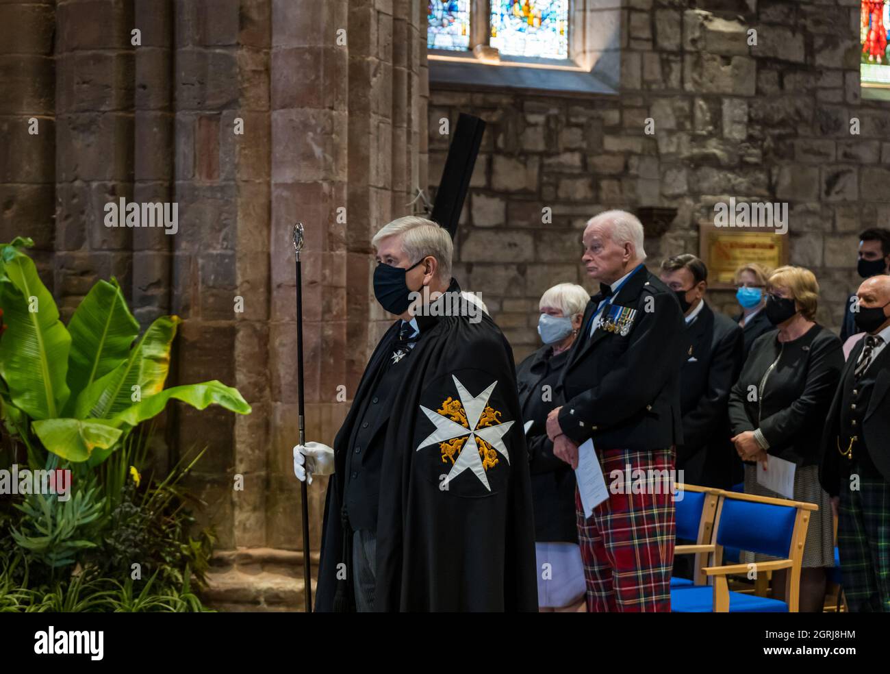 Haddington, East Lothian, Scotland, UK, 01 October 2021, St John Festival:  postulants receive medals in a ceremony today. A new Prior, Chancellor and Dean are also installed. Pictured: the master of ceremony. Senior members of the Order wear black robes with white stars Stock Photo