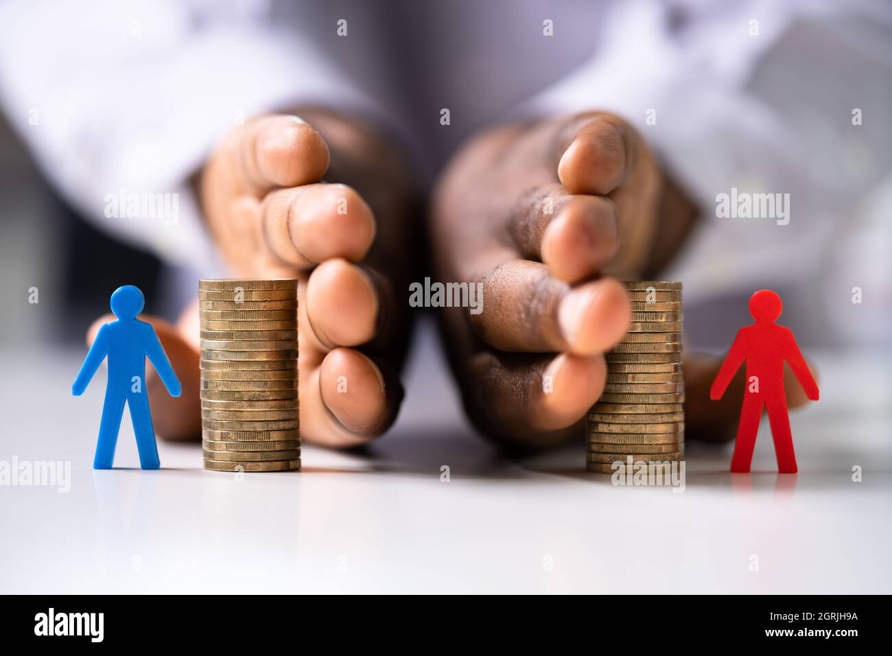 African American Hand Separating Money. Income And Investment Stock Photo