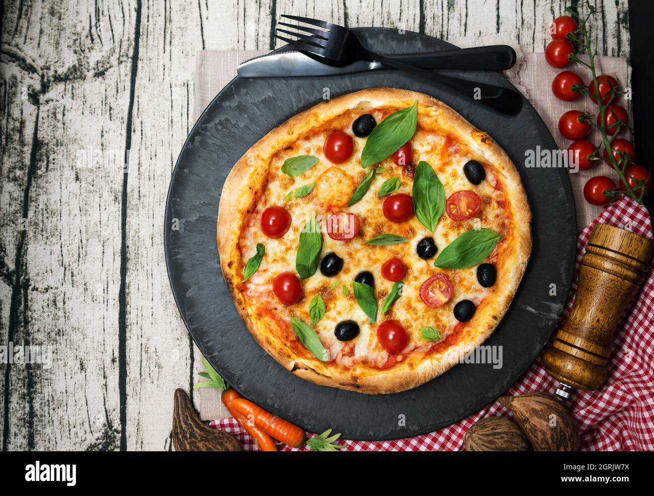High Angle View Of Pizza In Plate On Table Stock Photo