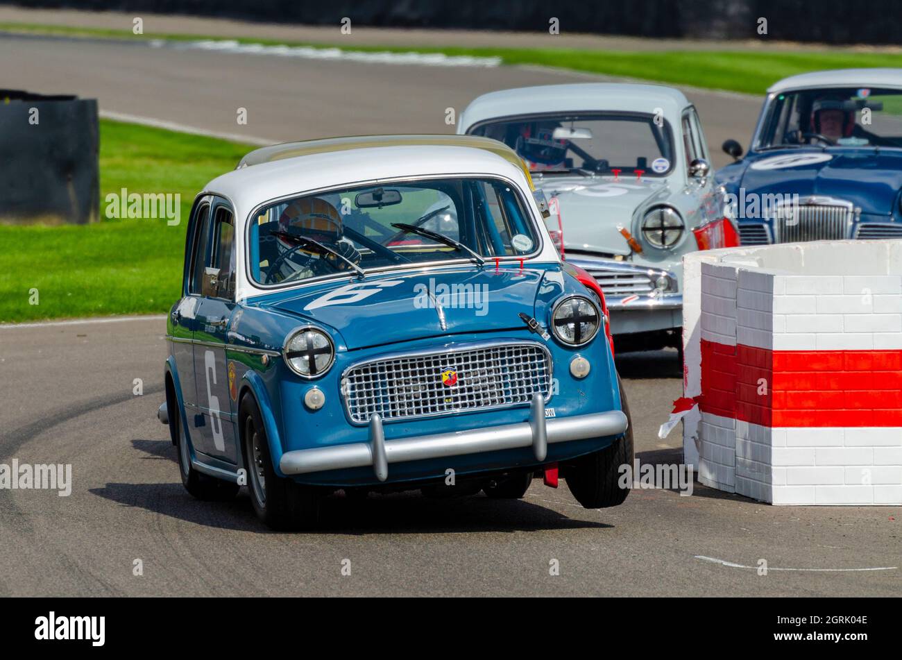 FIAT 1100 classic, vintage race car, racing in the St Mary’s Trophy for 1950s production saloons at the Goodwood Revival 2014. Wheel high cornering Stock Photo