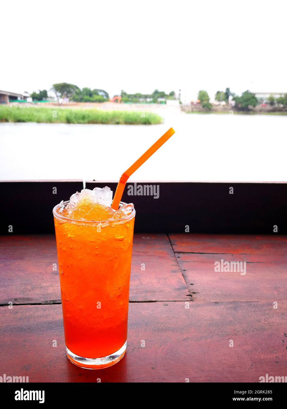 Close-up Of Drink On Table With Lake In Background Stock Photo