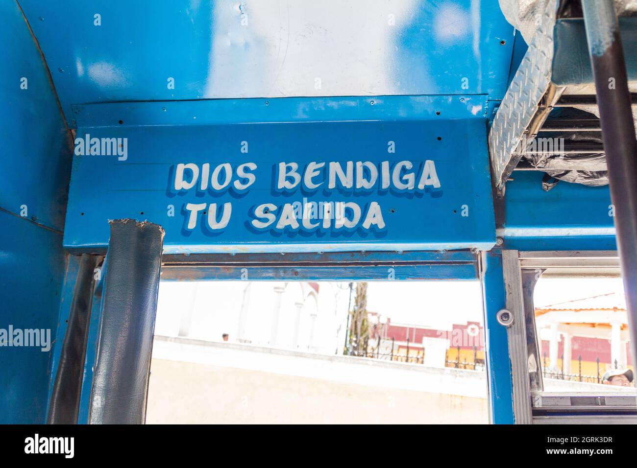 SAN MATEO IXTATAN, GUATEMALA, MARCH 19, 2016: Door of a local bus in Guatemala. Text says: God bless your getting off. Stock Photo