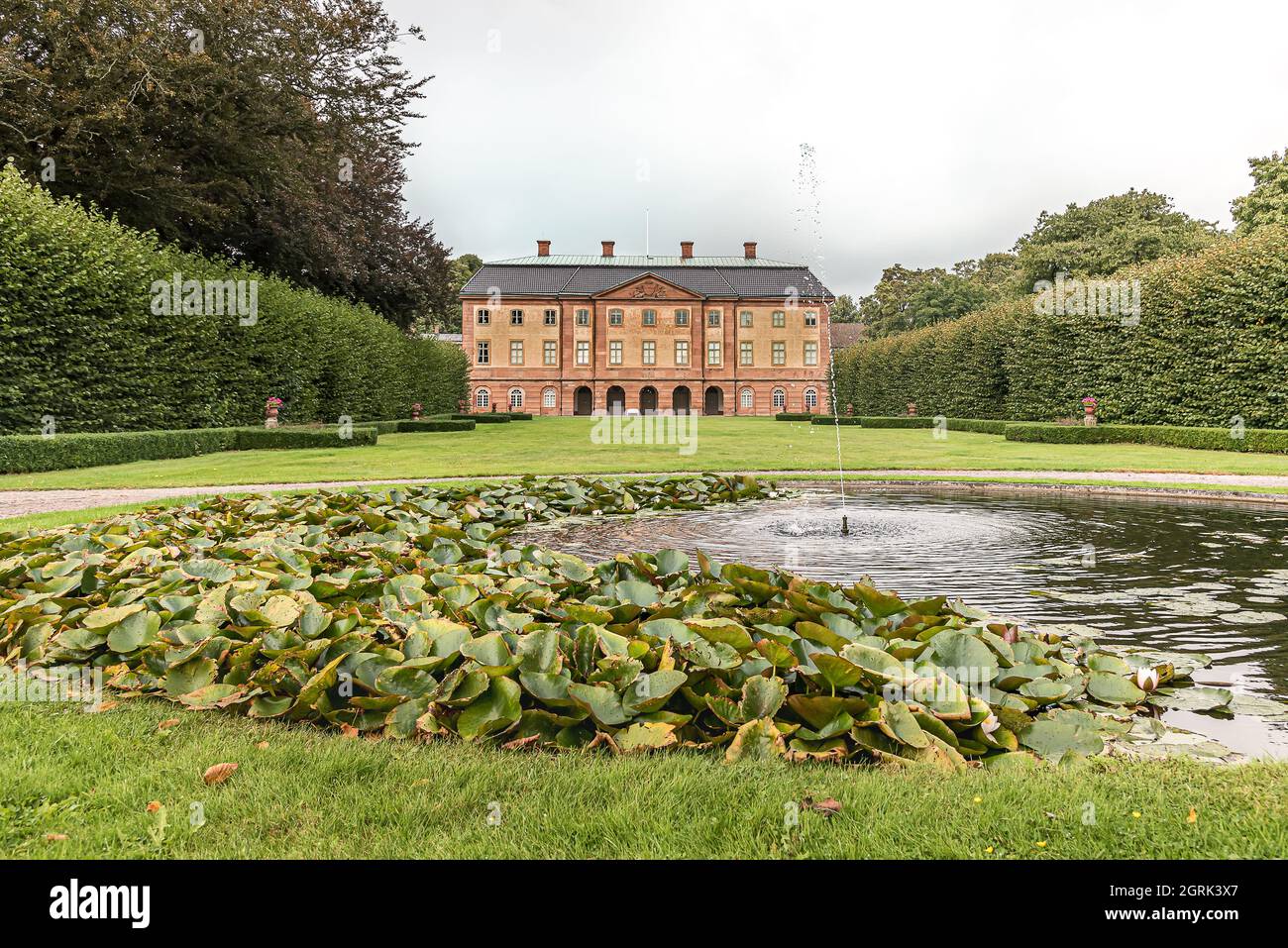 fountain and pond in front of the big manor house and park of Ovedskloster, Sjobo, Sweden, September 16, 2021 Stock Photo