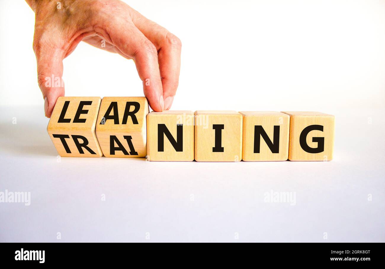 Training and learning symbol. Businessman turns wooden cubes and ...
