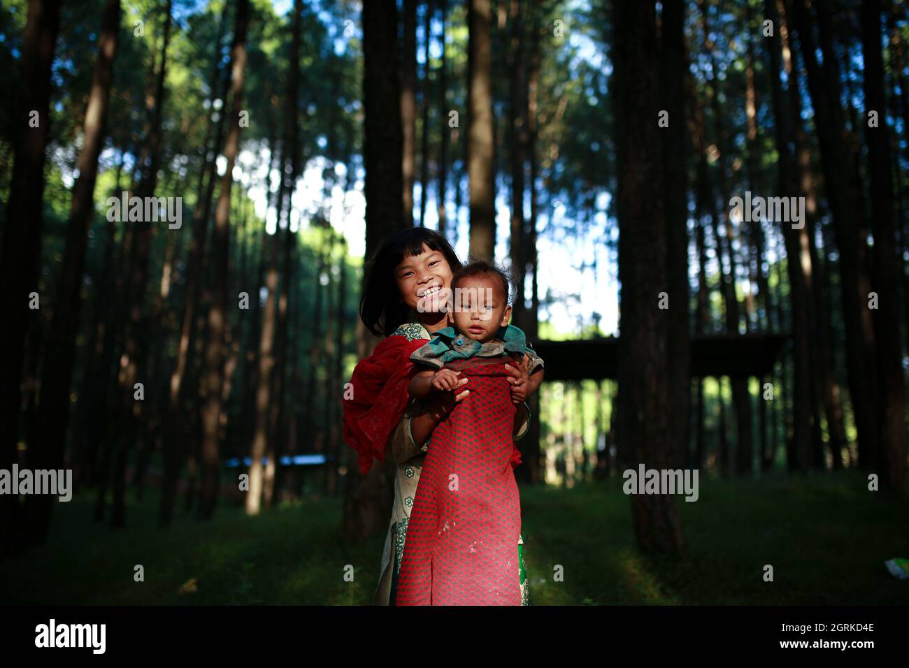 Bhaktapur, Bagmati, Nepal. 1st Oct, 2021. Girl carrying her younger
