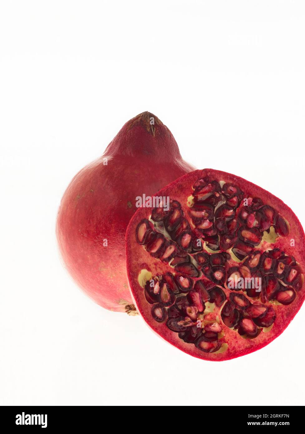 Pomegranate (Punica granatum), fruit still life against plain background Stock Photo