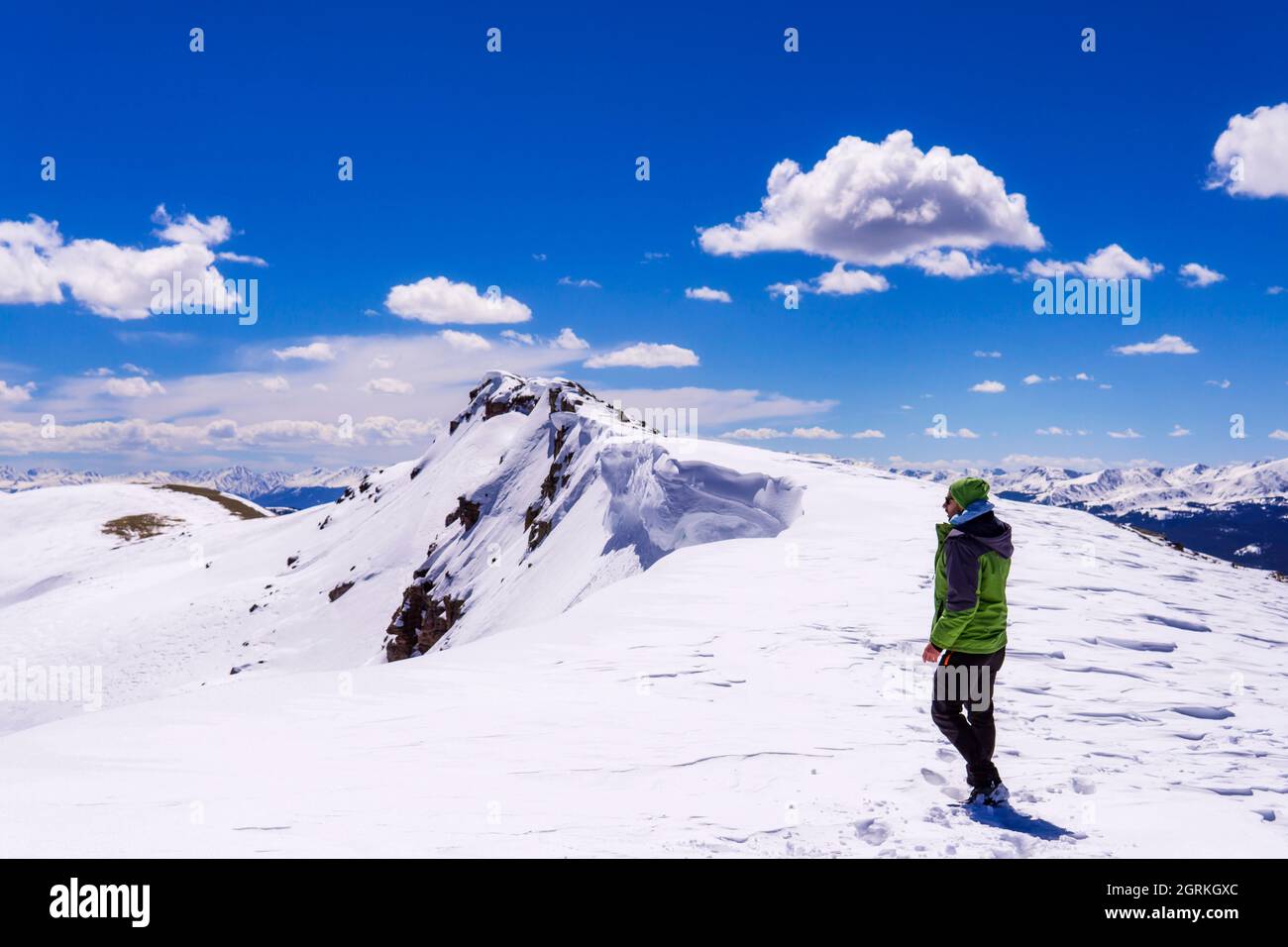 Man Exploring Winter Mountain Summit Hike Extreme Cold Stock Photo