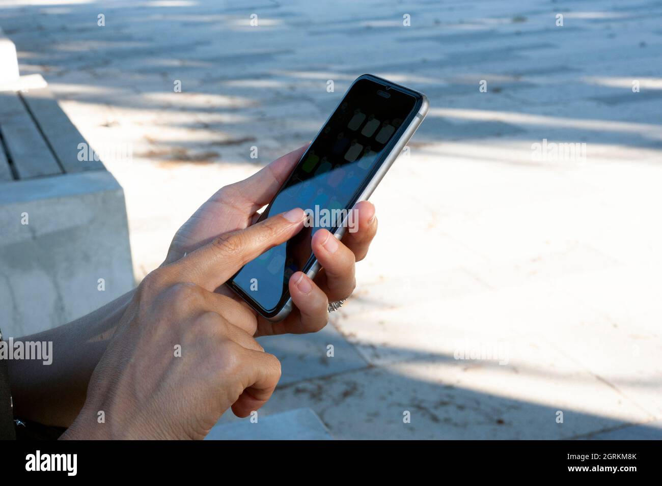 Woman while using the phone, touch the screen. Stock Photo