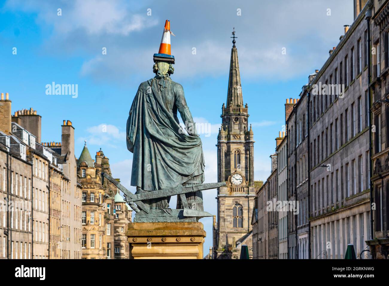A traffic cone has been added to the statue of Adam Smith on the Royal Mile in Edinburgh Old Town, Scotland, UK Stock Photo