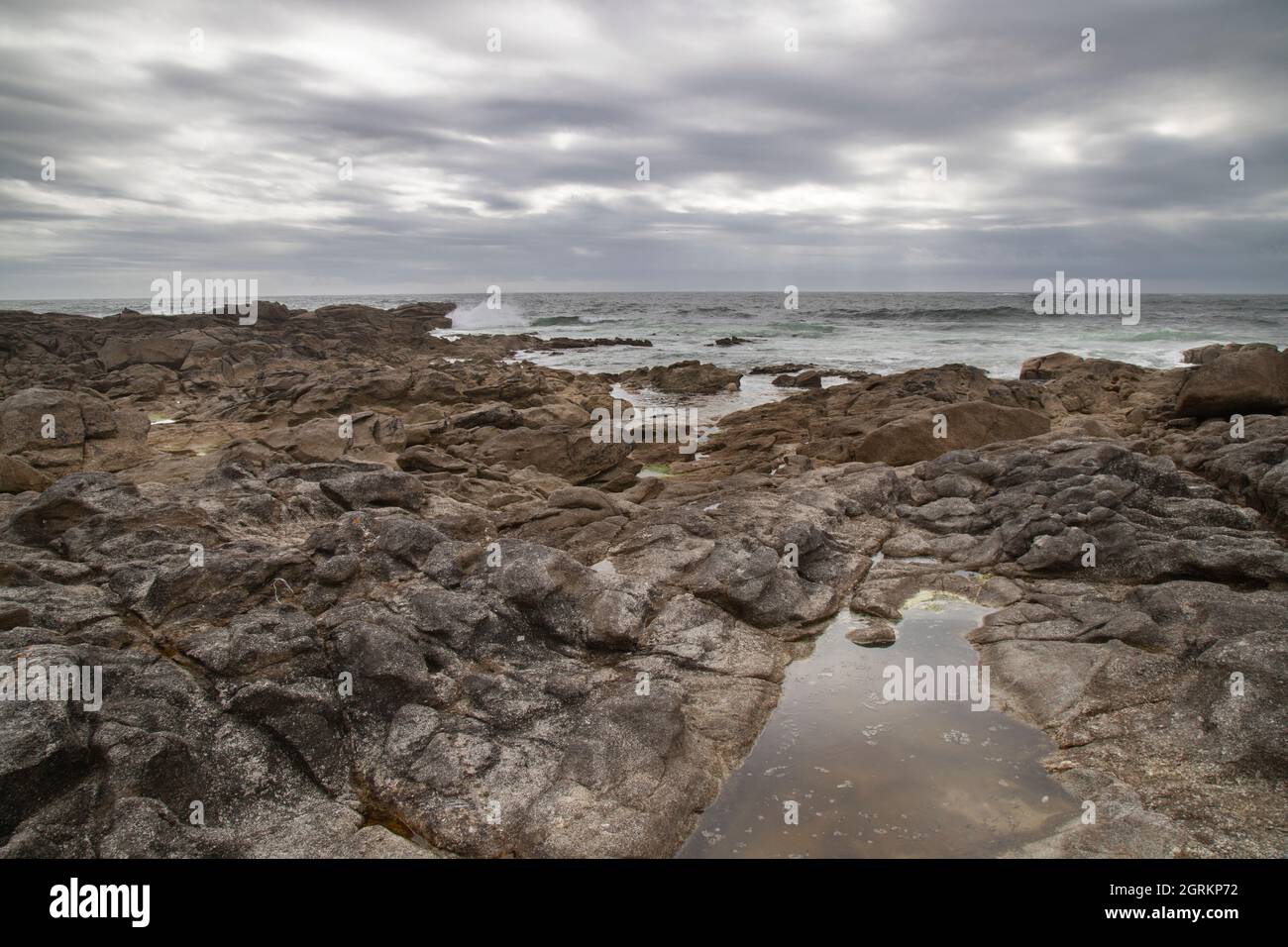 Wild seascape showing some rocks among the waves in Lariño in Galicia Spain Stock Photo