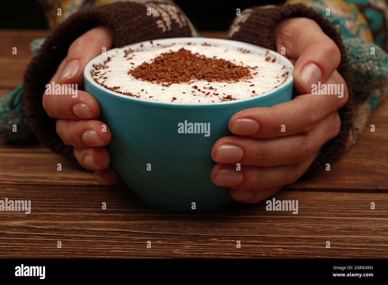 Cropped Hands Of Woman Holding Coffee Cup On Table Stock Photo