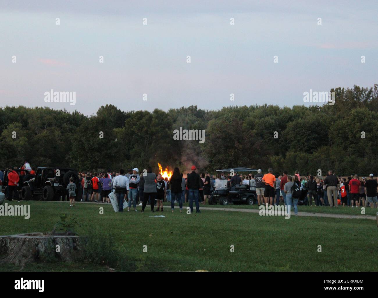 Unmasked people crowded at a bonfire for homecoming 2021 in a rural town in Ohio. Stock Photo