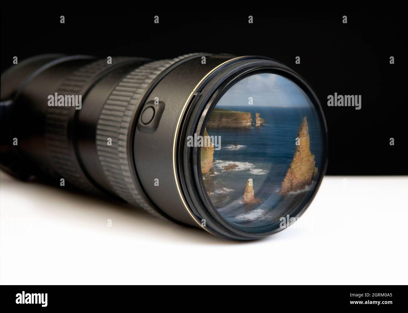 Digital zoom lens with landscape photo embedded on end, depicting concepts of the bigger picture, I spy, observation or the way forward Stock Photo