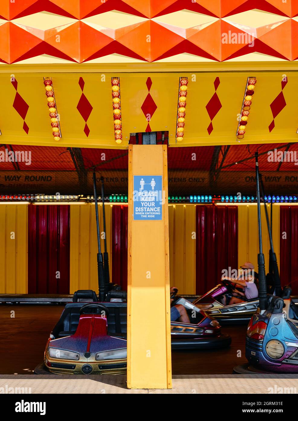 A social distancing covid keep 2 metres apart at a fairground bumper