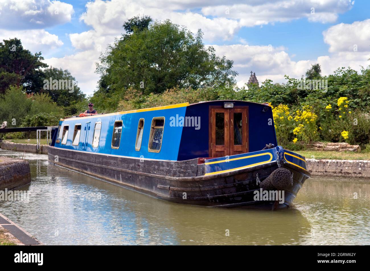 Canal boat travelling along the Kennet and Avon Canal, through Caen hill locks, Devizes, WIltshire Stock Photo