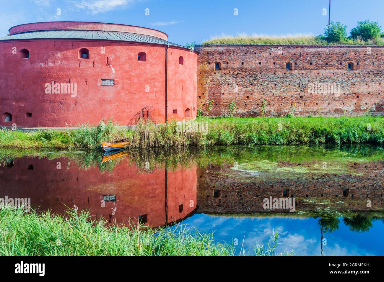 Fortification walls of Malmo Castle reflecting in its moat, Sweden Stock Photo