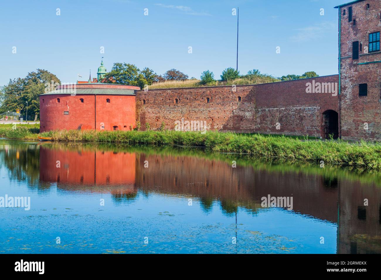 Fortification walls of Malmo Castle reflecting in its moat, Sweden Stock Photo
