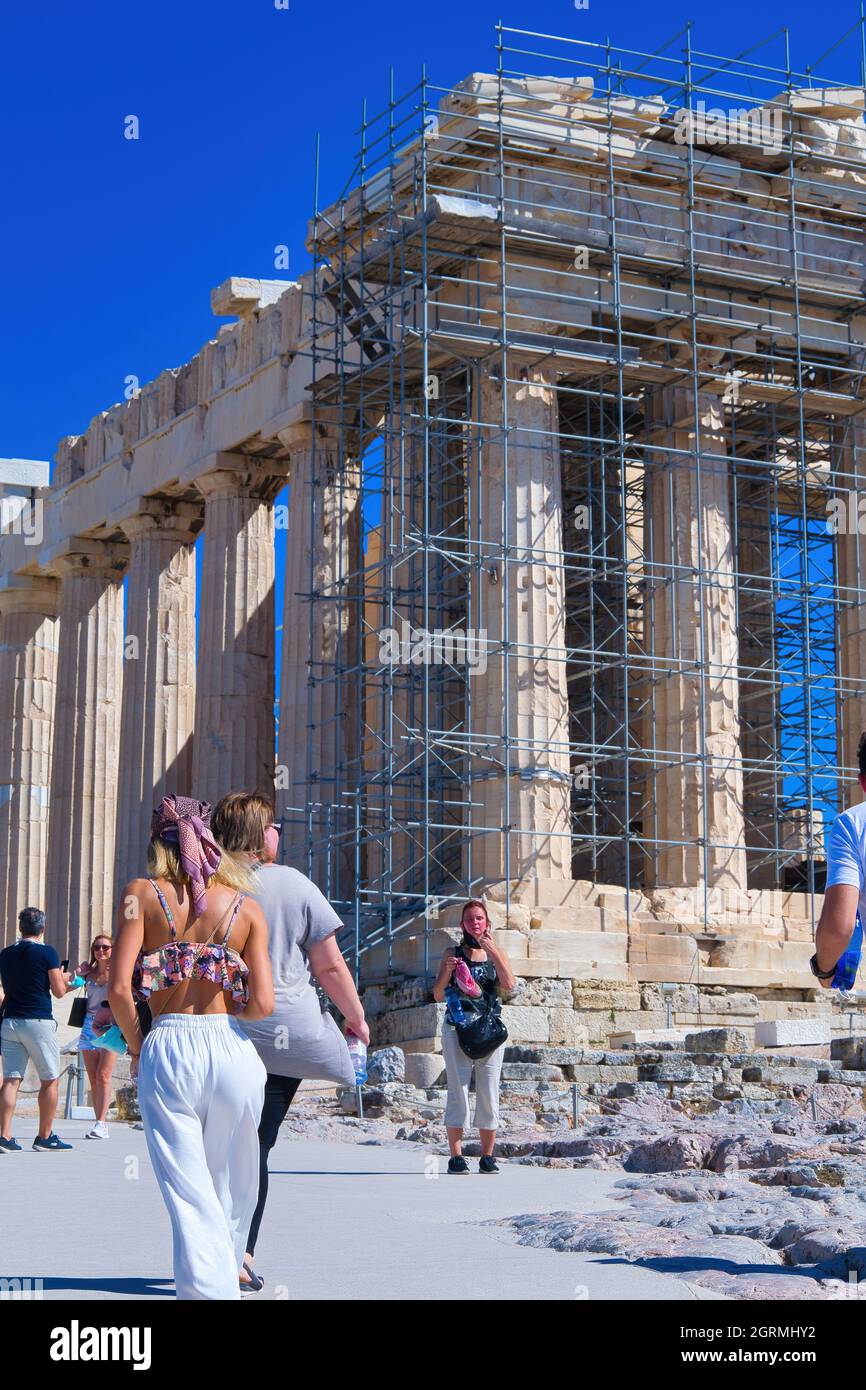 beautiful girl , with a headscarf on her head, posing in front of the Acropolis Parthenon Stock Photo