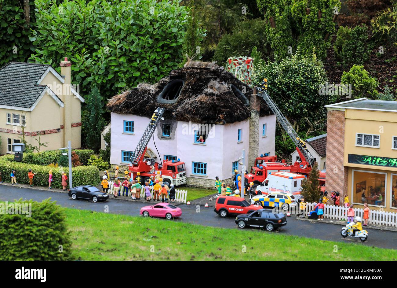 The fire brigade attending a fire at a thatched cottage at Babbacombe Model Village, Babbacombe, Torquay, Devon, England, UK Stock Photo