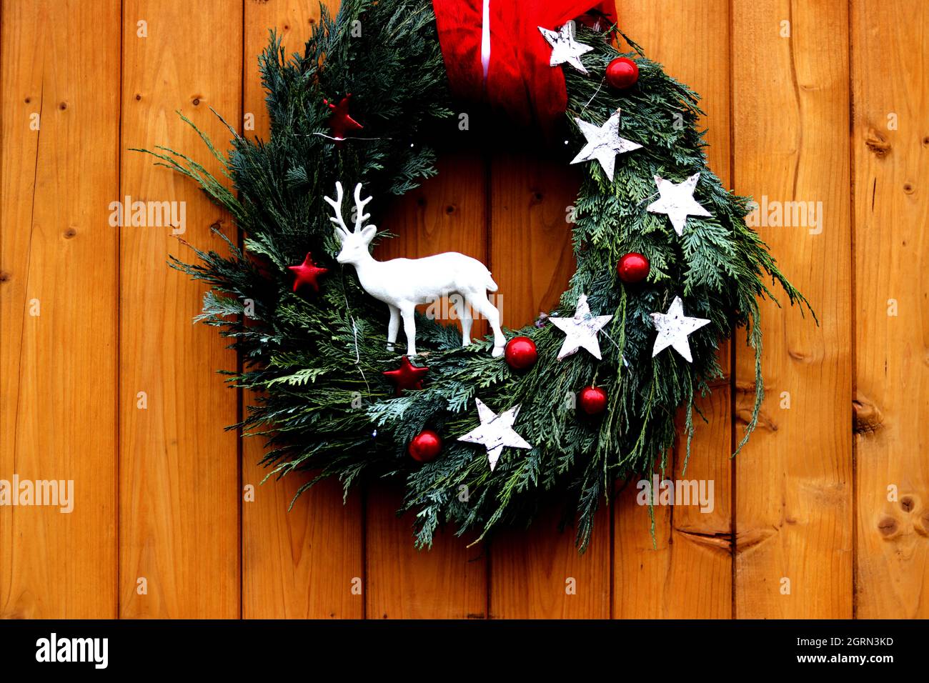 Christmas wreath with reindeer on a front wooden door - close up Stock Photo