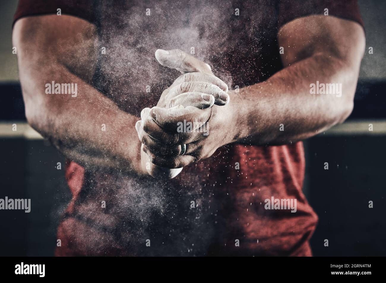 Athlete clapping hands with chalk dust for weight lifting Stock Photo