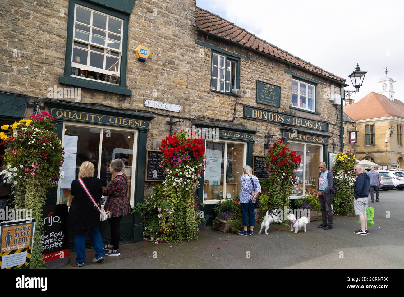 Hunters of Helmsley Delicatessen.two dogs play outside Stock Photo