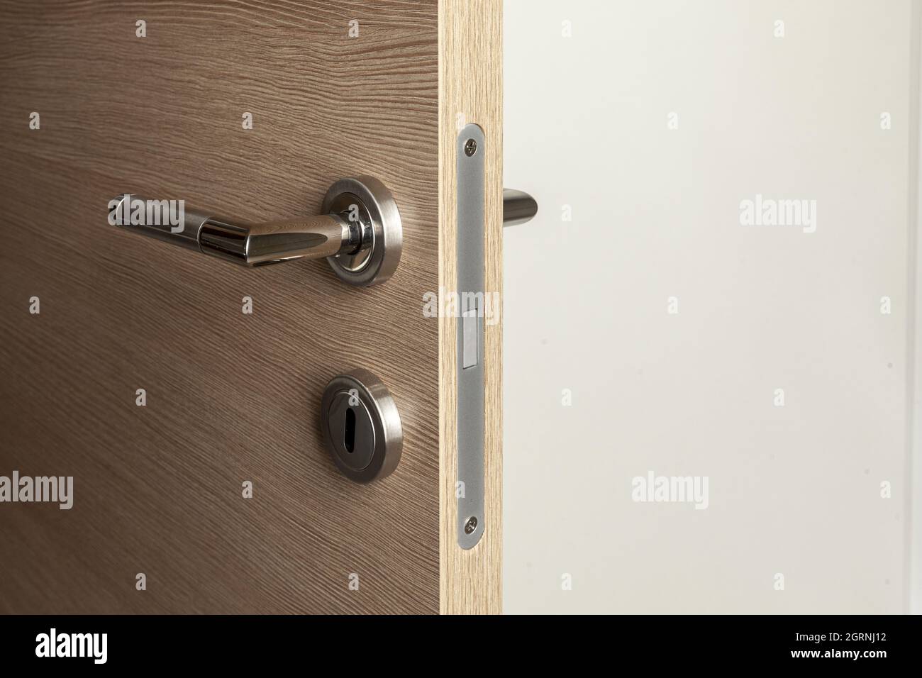 open wooden door with magnetic lock Stock Photo
