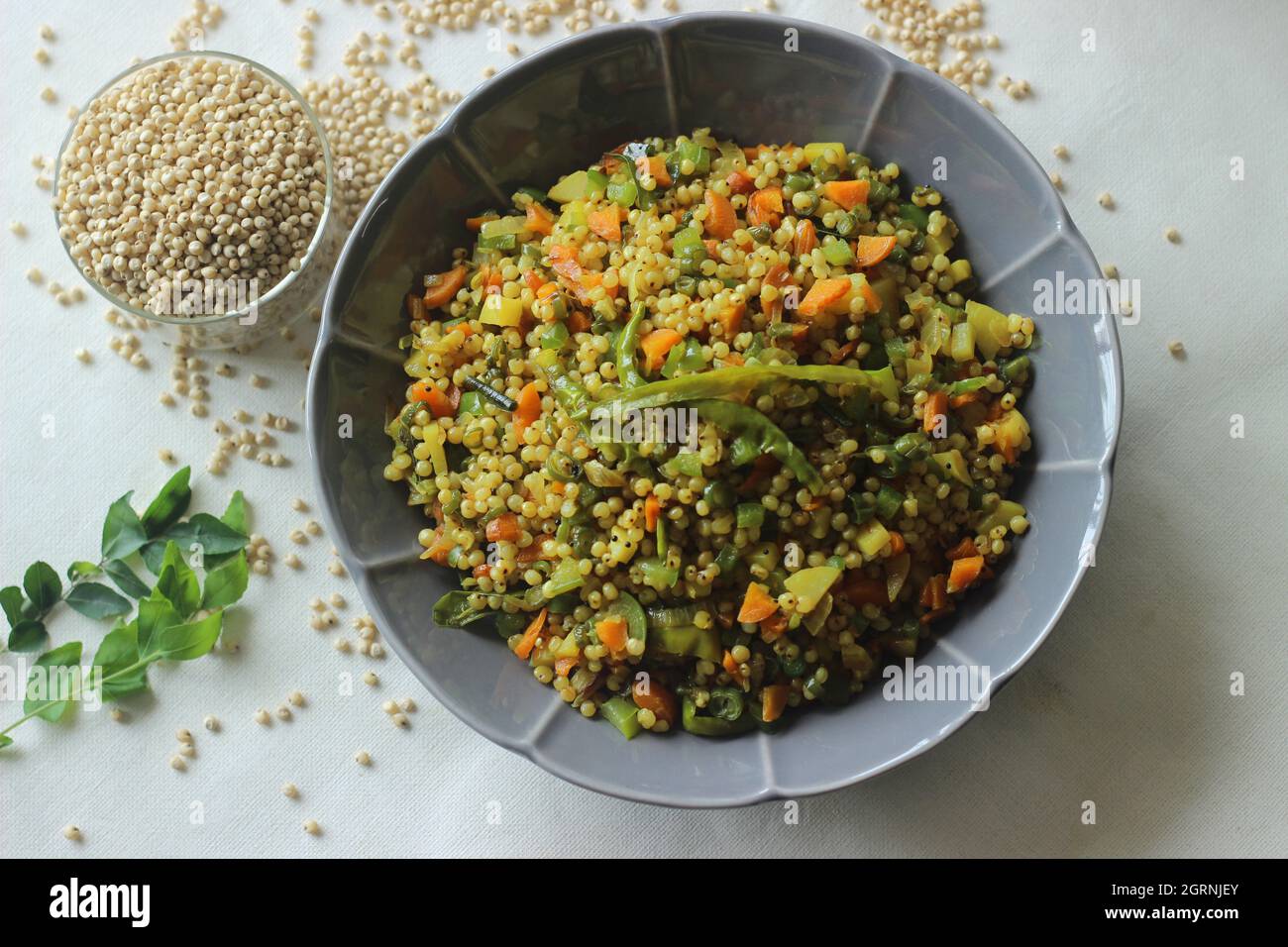 Sorghum upma. A South Indian breakfast dish with whole Sorghum and vegetables. Popularly known as jowar upma. Shot on white background Stock Photo