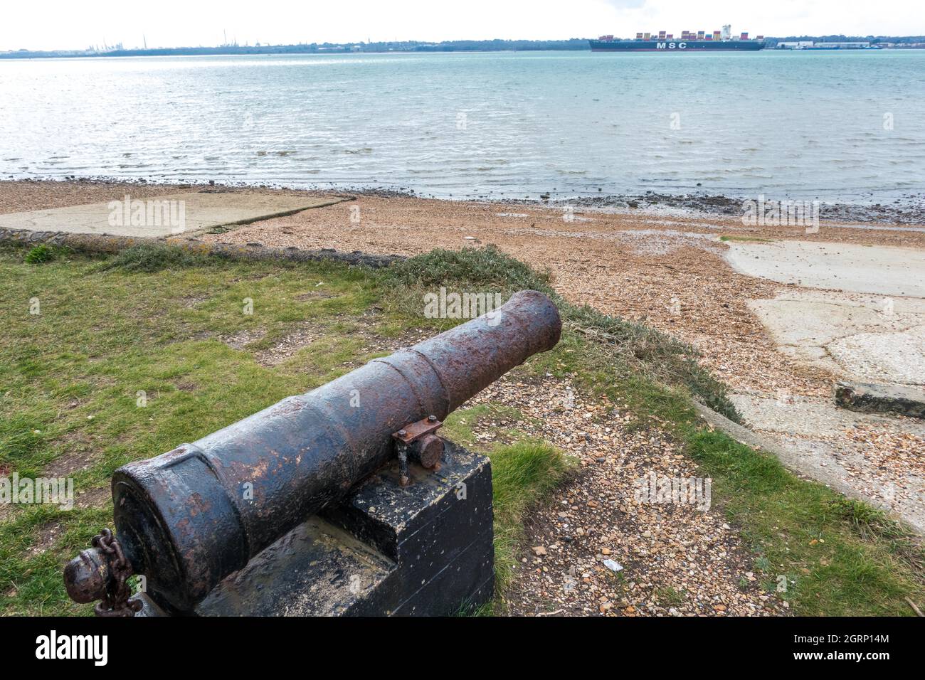 Canon overlooking Southampton water at Weston Sailing Club Hampshire England with container ship in background Stock Photo