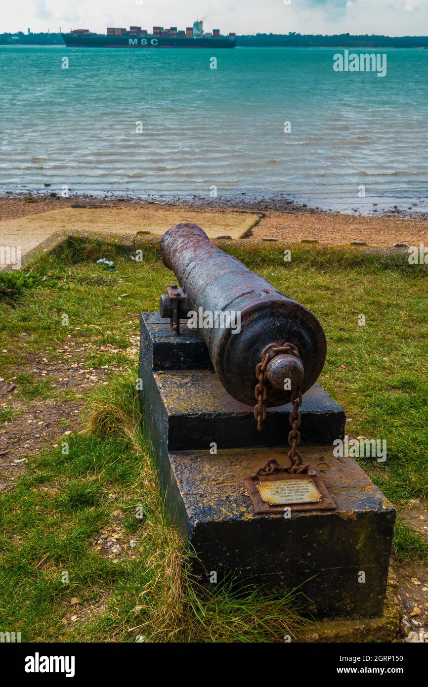 Canon overlooking Southampton water at Weston Sailing Club Hampshire England with container ship in background Stock Photo