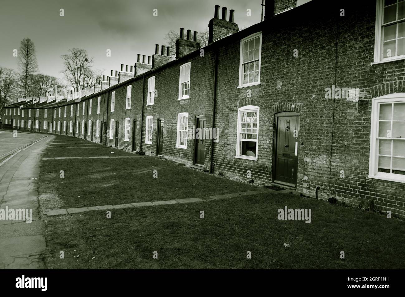 Row of classic English terraced cottages at Lower Park Street Cambridge England in black and white Stock Photo