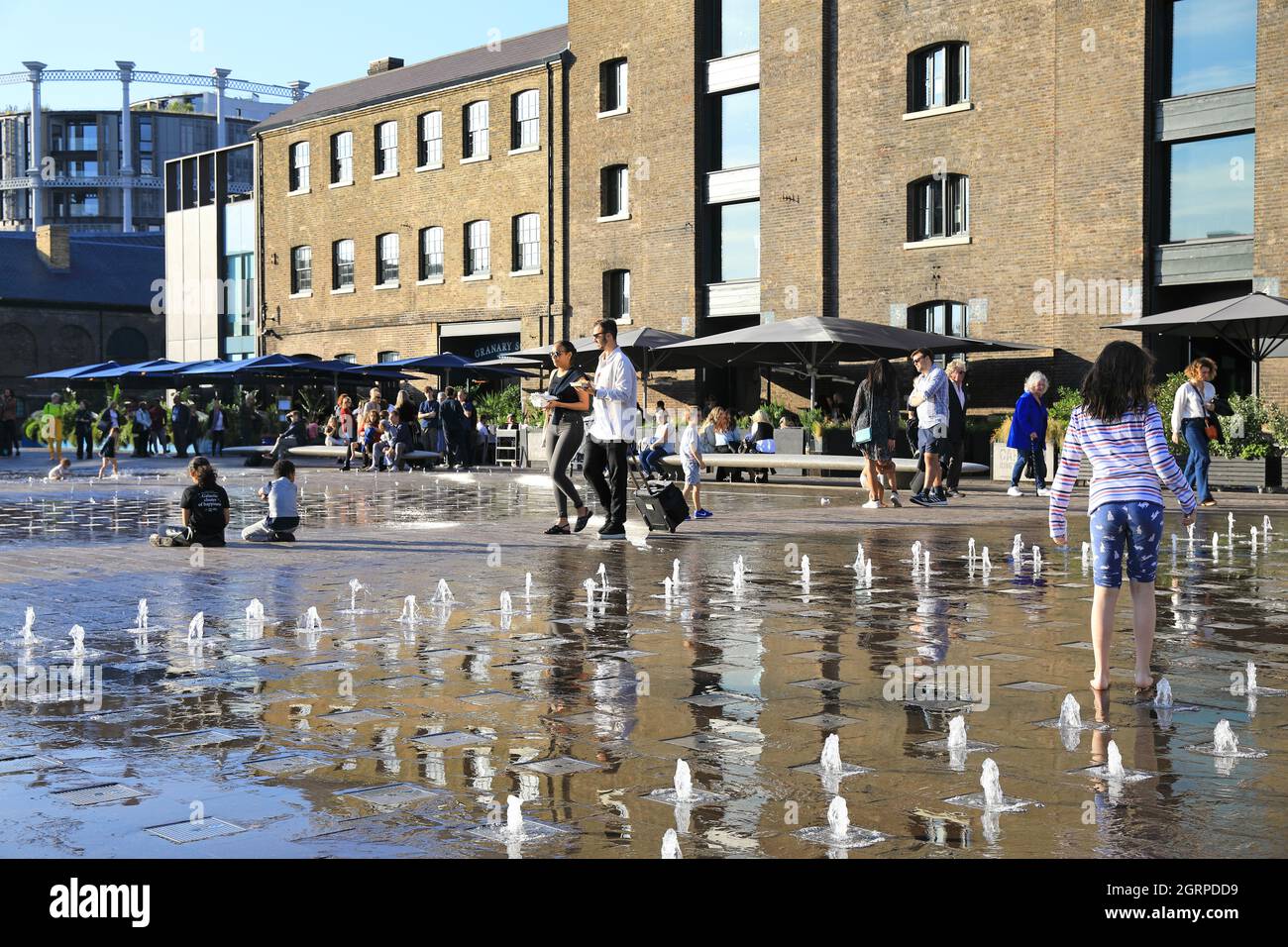 Autumn sunshine on the fountains in Granary Square, with St Martins
