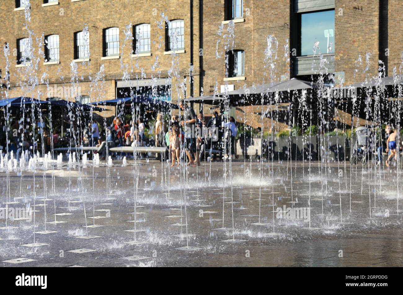 Autumn sunshine on the fountains in Granary Square, with St Martins