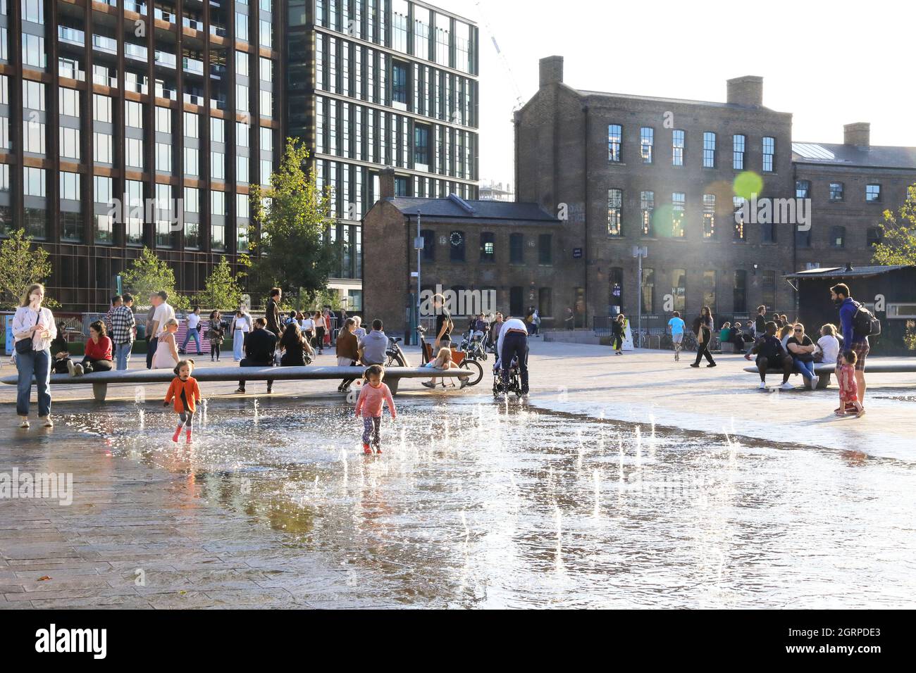 Autumn sunshine on the fountains in Granary Square, at Kings Cross, in London, UK Stock Photo