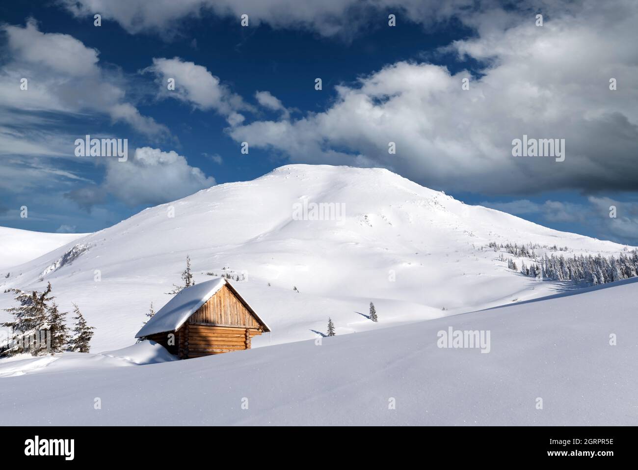 Fantastic winter landscape with wooden house in snowy mountains ...