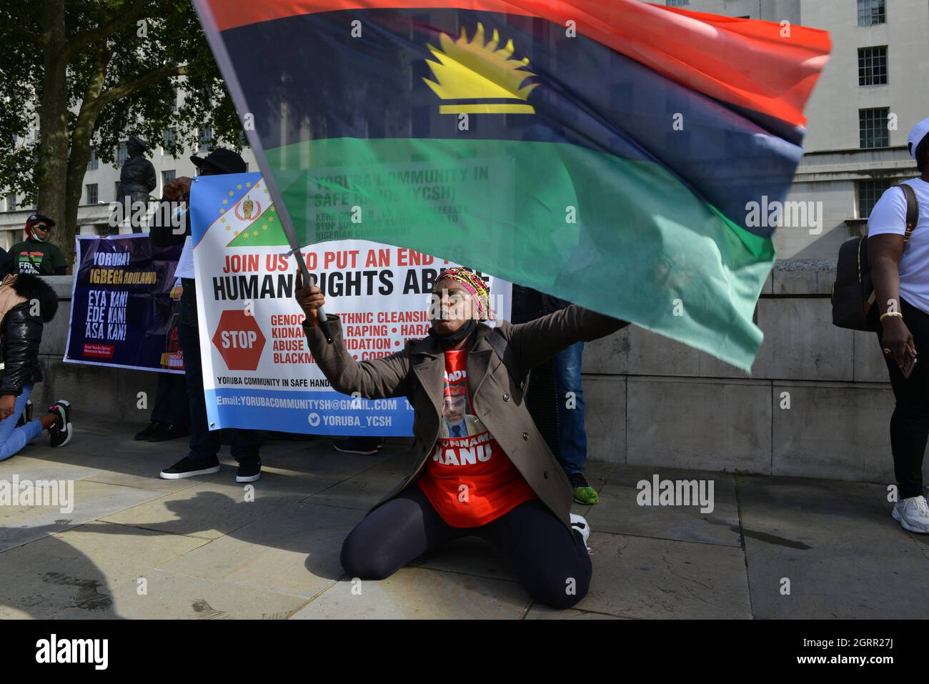 A protester holds a flag during the demonstration. People of Biafra (Eastern part of Nigeria) and The Indigenous People of Biafra, gathered at Trafalgar Square, and marched to Downing Street demanding the referendum to be conducted in Nigeria for peaceful separation of Biafra from Nigeria. Stock Photo