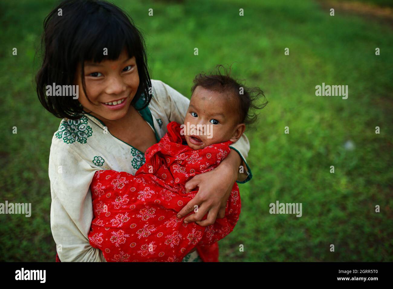 October 1, 2021, Bhaktapur, Bagmati, Nepal Girl carrying her younger