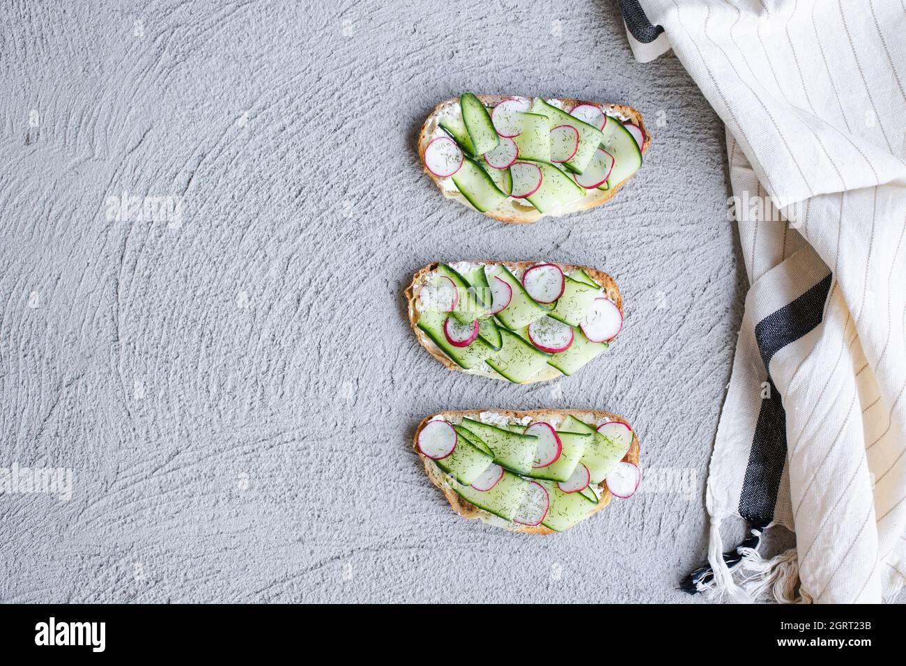 colorful and delicious plate, a toast with cucumber cream cheese Stock Photo