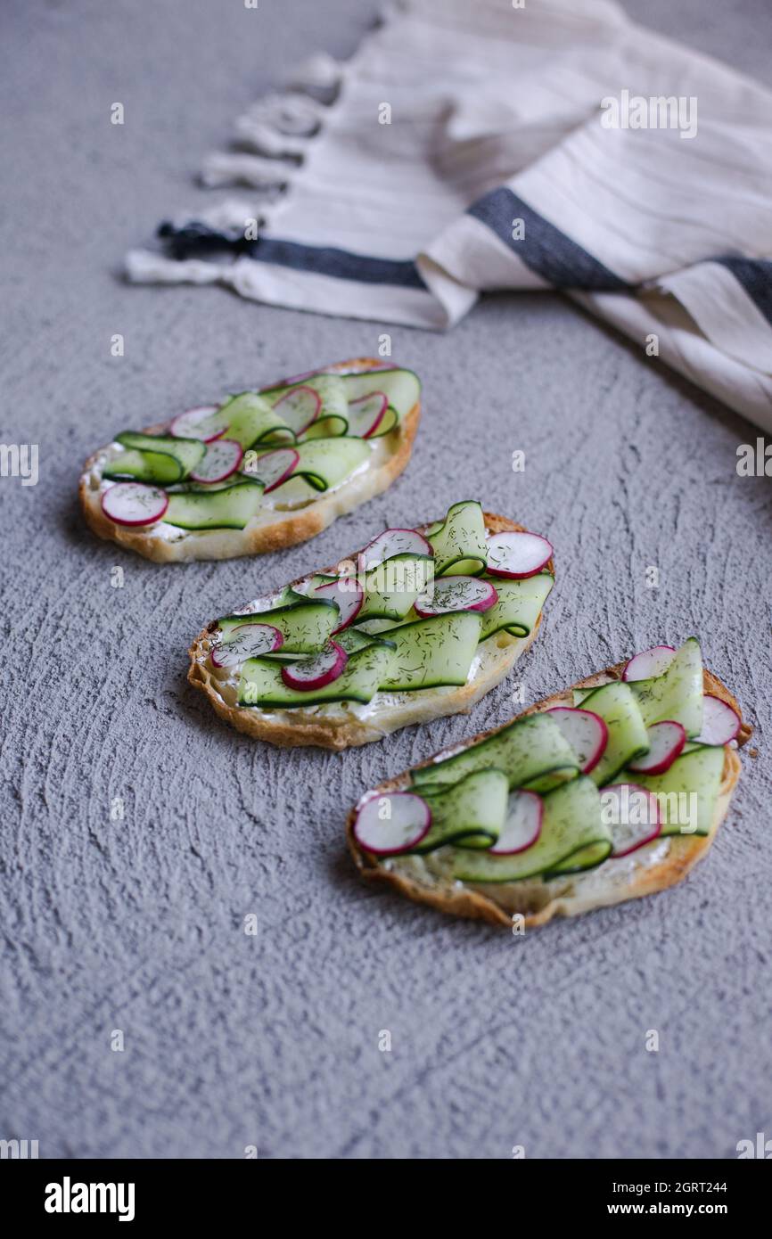 colorful and delicious plate, a toast with cucumber cream cheese Stock Photo