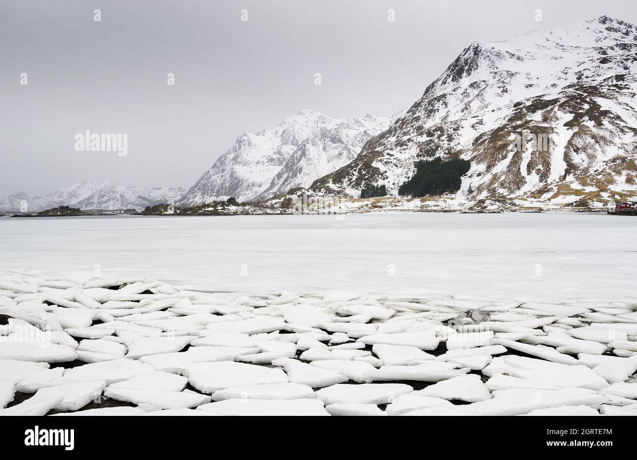 Scenic View Of Frozen Lake By Mountain Against Sky Stock Photo