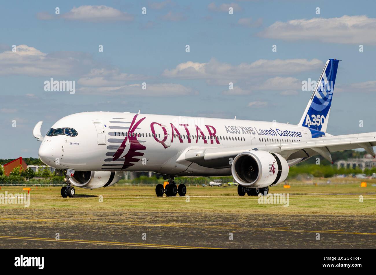 Airbus A350 jet airliner plane making the brand new type's public debut at Farnborough 2014 in Qatar livery. XWB (extra wide body) launch customer Stock Photo