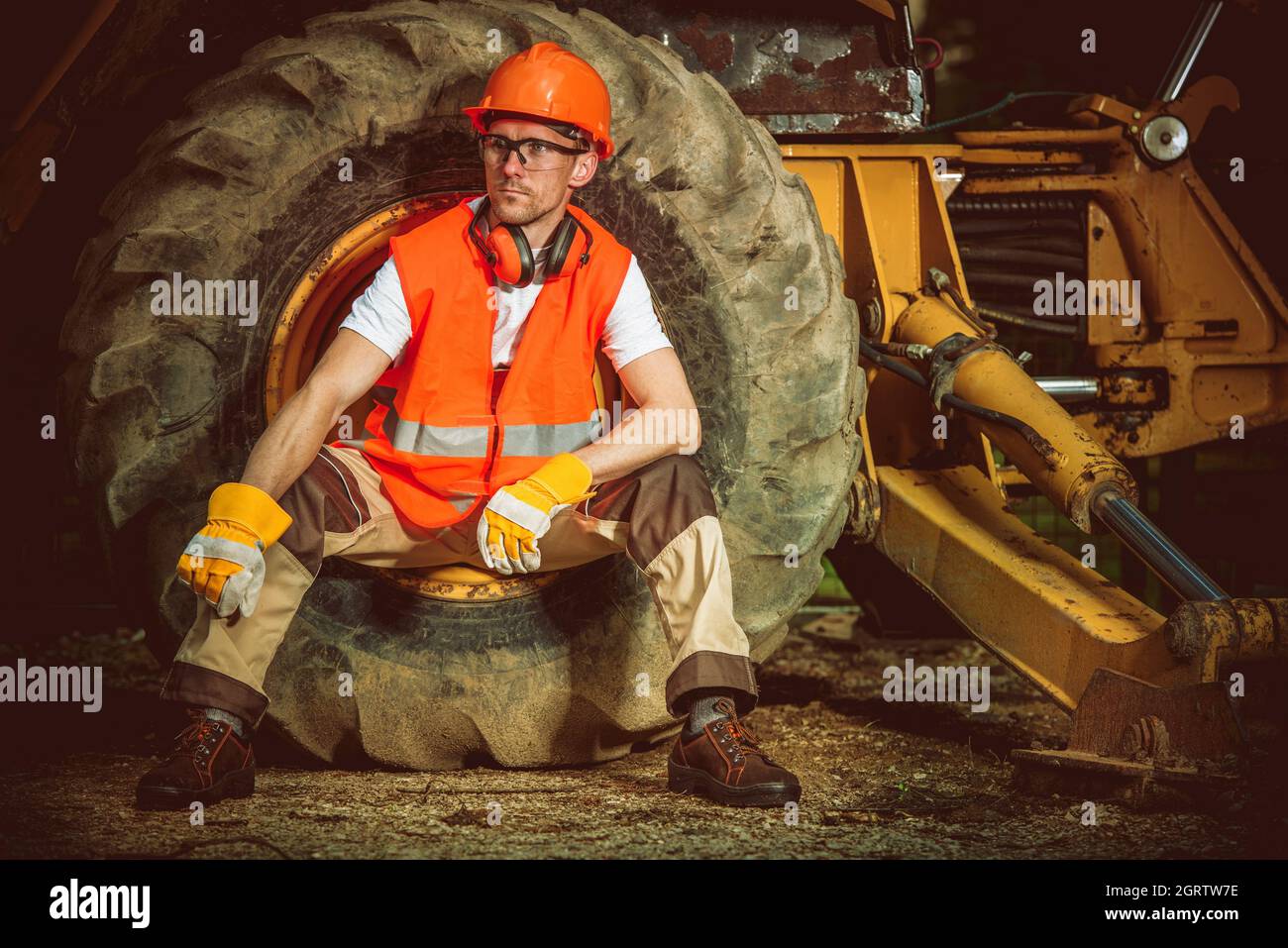 Engineer Sitting On Tire In Factory Stock Photo Alamy